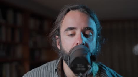 man singing into a microphone at home