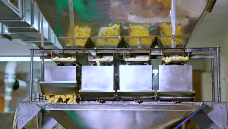 industrial food products manufacturing at modern factory. metal equipment for producing vegetarian maize snacks.