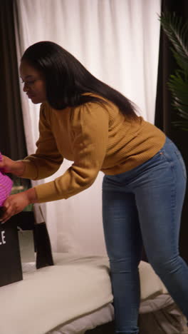 woman arranging gifts in a bedroom