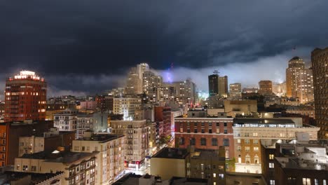 san francisco downtown cityscape night timelapse taylor and geary street dramatic clouds and mist over the buildings fast moving bright traffic static shot