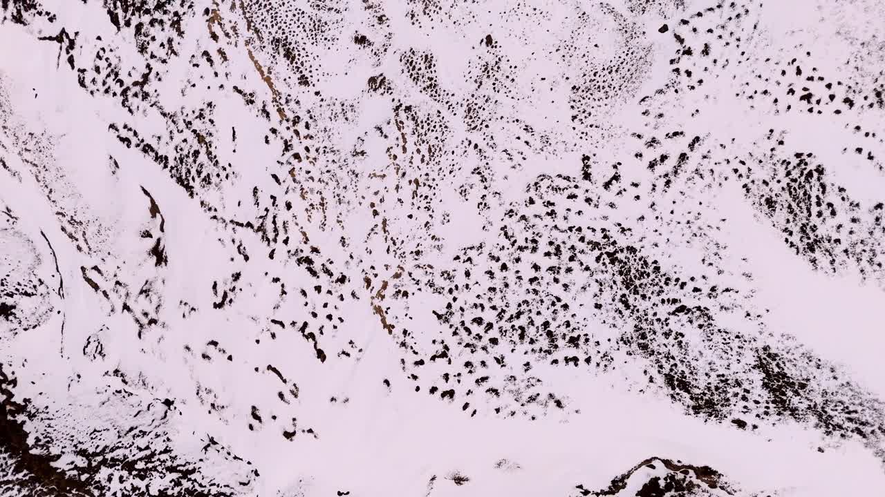 drone aerial top down of snow covered valley in Iceland near Waterfall of the Gods Godafoss