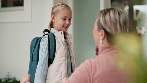 mother, child and backpack for school