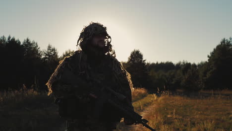 Armed-With-A-Man-Walking-On-A-Country-Road-At-Sunset