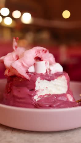 pink cake dessert with cotton candy and marshmallows