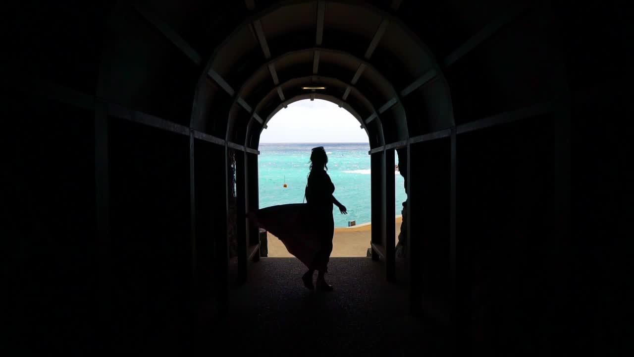 Cinque Terre, Liguria, Italy - A Silhouetted Woman Dances at the End of a Seaside Tunnel - Slow Motion Shot