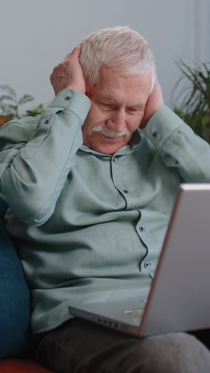 Grandfather old man use laptop surprised by bad news fortune loss fail lottery results at home
