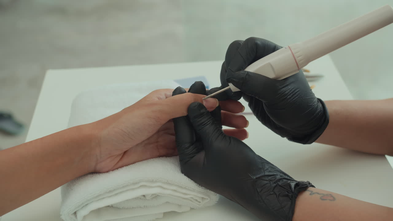Expert Working with Clients Nails Using Tool at Salon