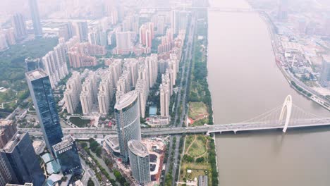Aerial-view-Panoramic-Guangzhou-City-buildings-and-River,-morning-lights---Tilt-up-shot
