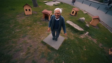 Man balancing on a stone in a park