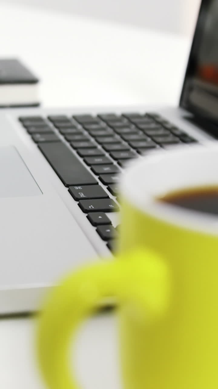 Laptop with personal organizer and pen on the table