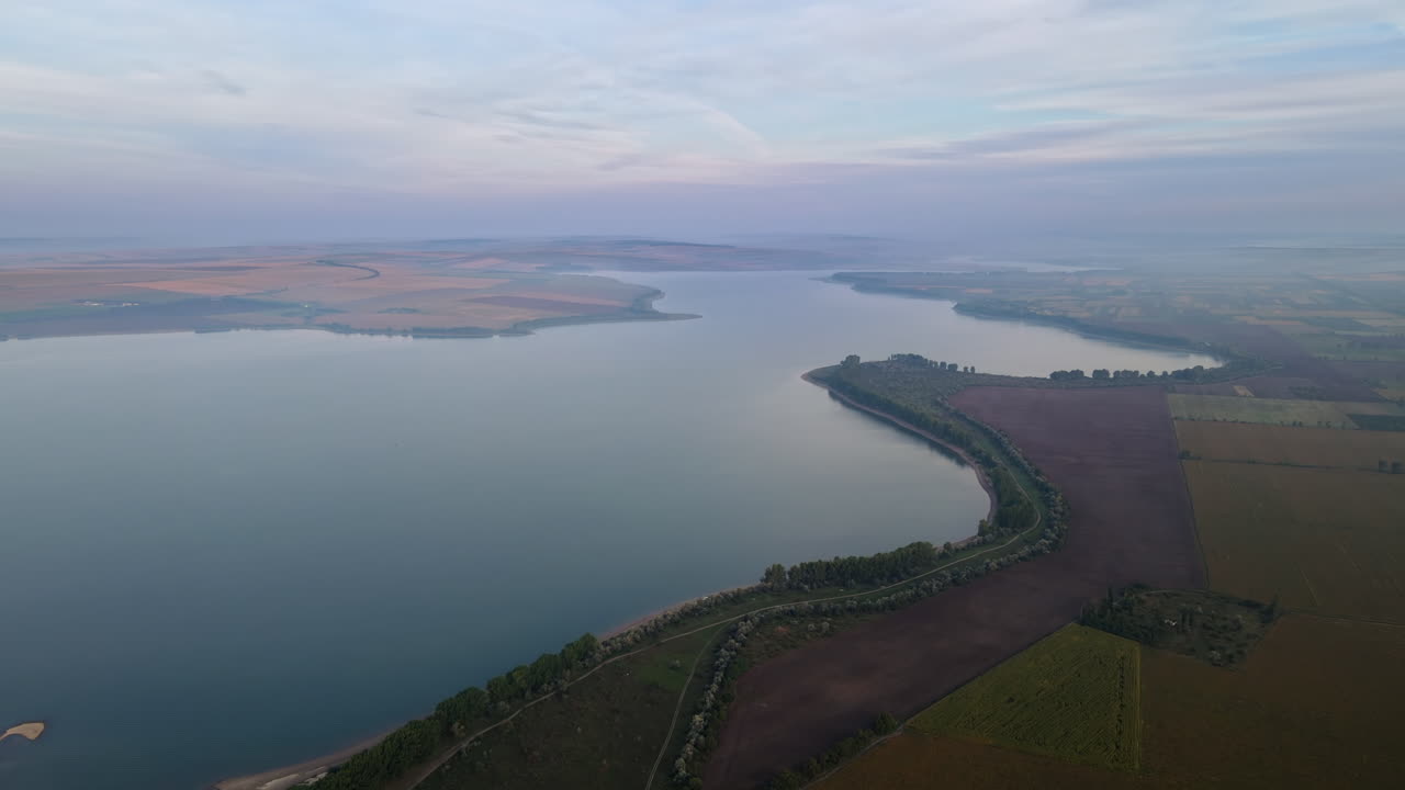 Aerial drone view of the Duruitoarea natural reservation in Moldova. River and fog in the air, fields