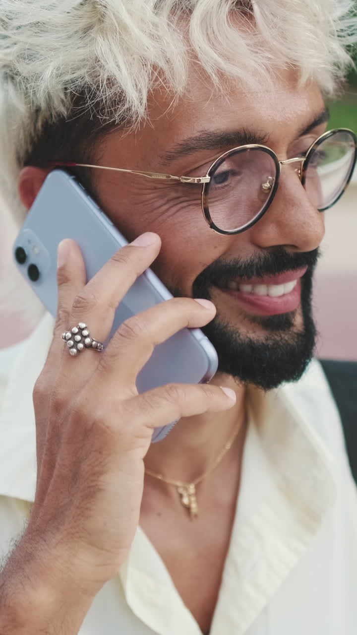 Close-up of a Happy Man Talking on a Smartphone Outdoors