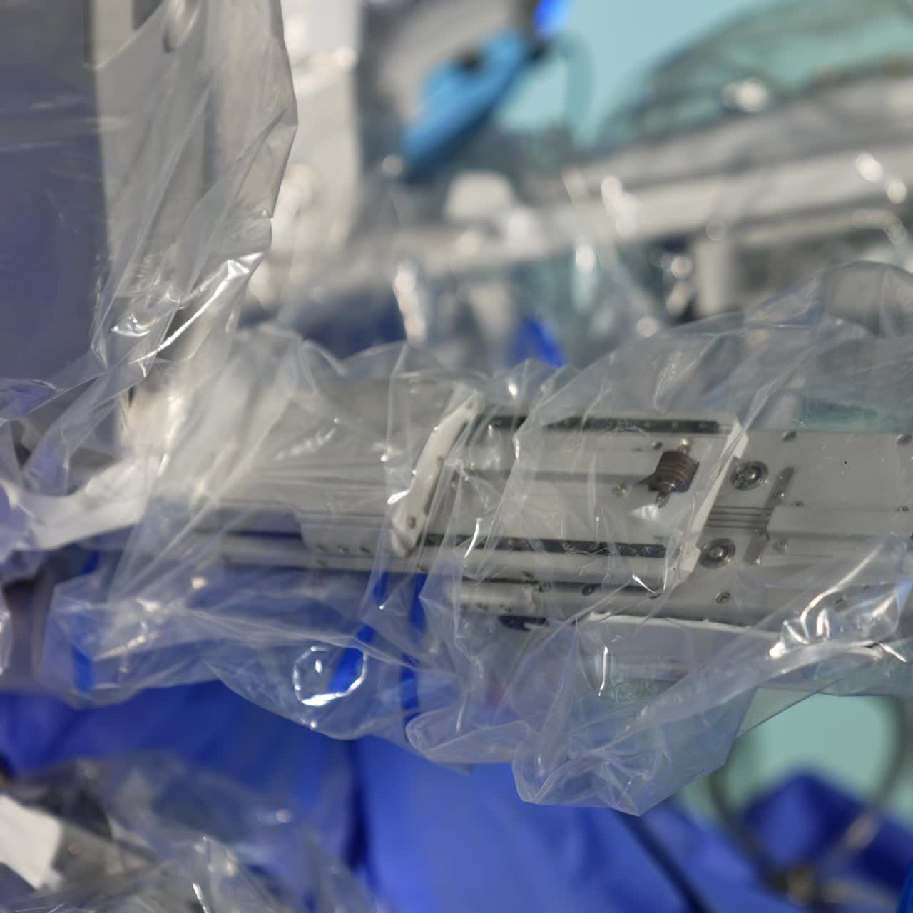 Plastic covering the manipulator arms of a surgery robot. Close up. Da Vinci system carrying out the operation in modern clinics