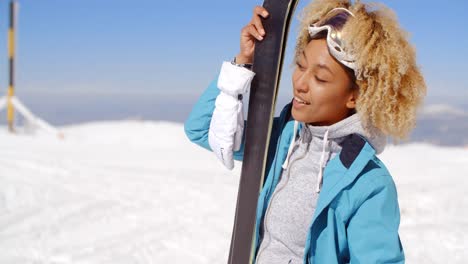 beautiful woman holding skis with copy space