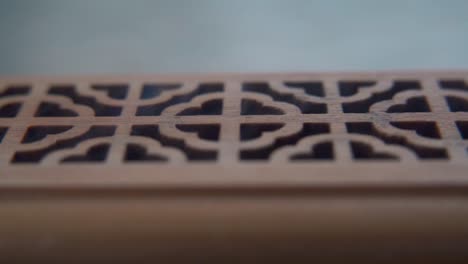 a close-up macro shot of smoking incense in a wooden box, spiritual ritual meditation, scented therapy fragrance, relaxing aromatic white smoke, textured case, cinematic static slowmo video 120 fps