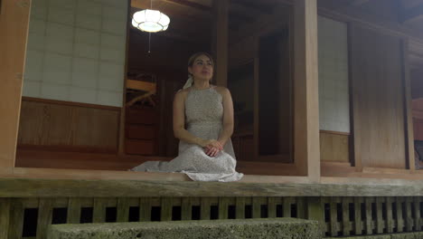 latin woman female model relaxing and smile at japanese traditional house at tamaudun mausoleum okinawa japan