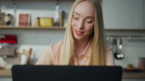 woman manager finishing online meeting on web camera sitting kitchen close up.