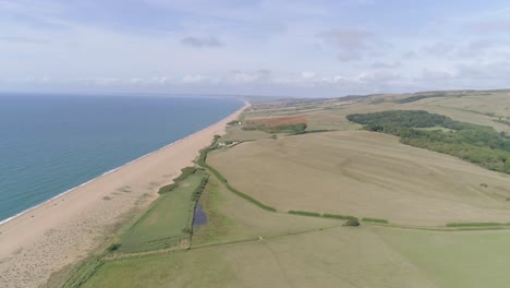 aerial tracking from right to left above the stunning chesil beach which stretches west along the coast