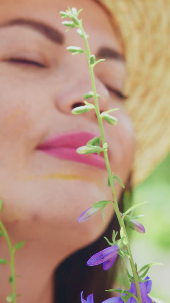 A Serene Moment of Connection with Nature: A Woman Enjoying the Beauty of Flowers Amidst Tranquil Surroundings