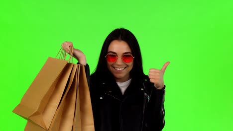 happy woman showing thumbs up after shopping