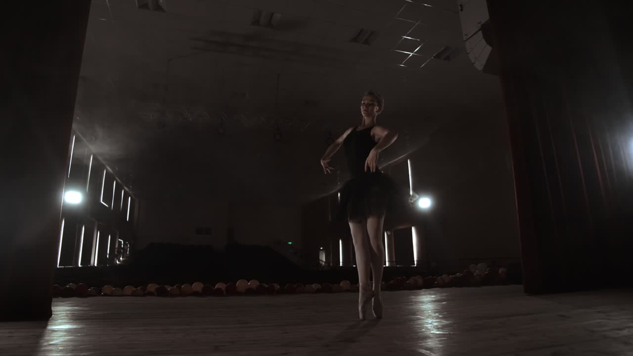 SLOW MOTION. unrecognizable beautiful ballerina performing on dark smoke stage. Blonde woman with hair in black. Ballet dress dancing with hands.