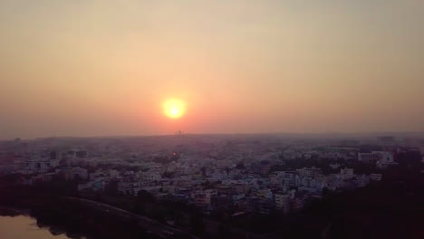 aerial pan shot of sunset with beautiful cityscape of hyderabad in india