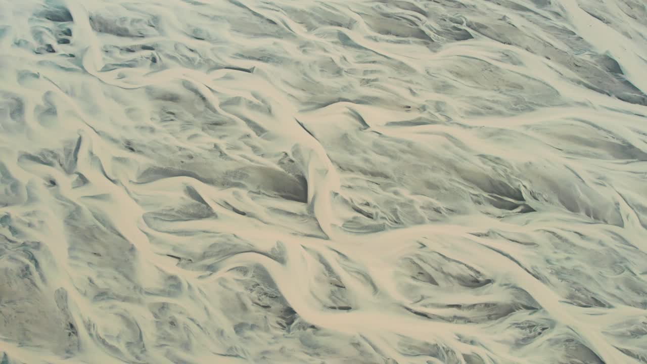 Aerial view of winding glacier river formations in Iceland.