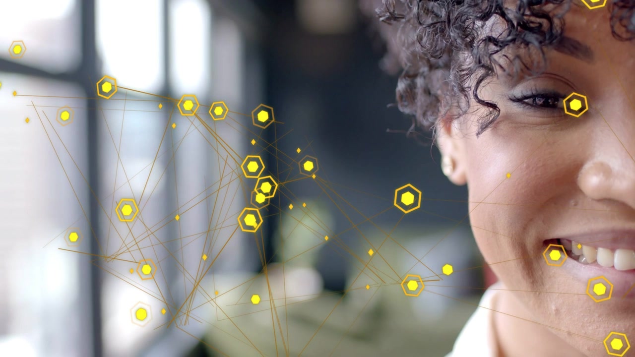 Animated yellow hexagonal nodes drifting across face, woman opening eyes and laughing for tech demo