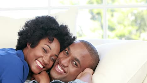 Attractive-couple-lying-on-the-couch-cuddling