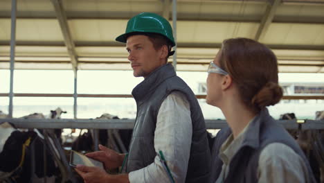 livestock owners walking shed together closeup. happy managers have conversation