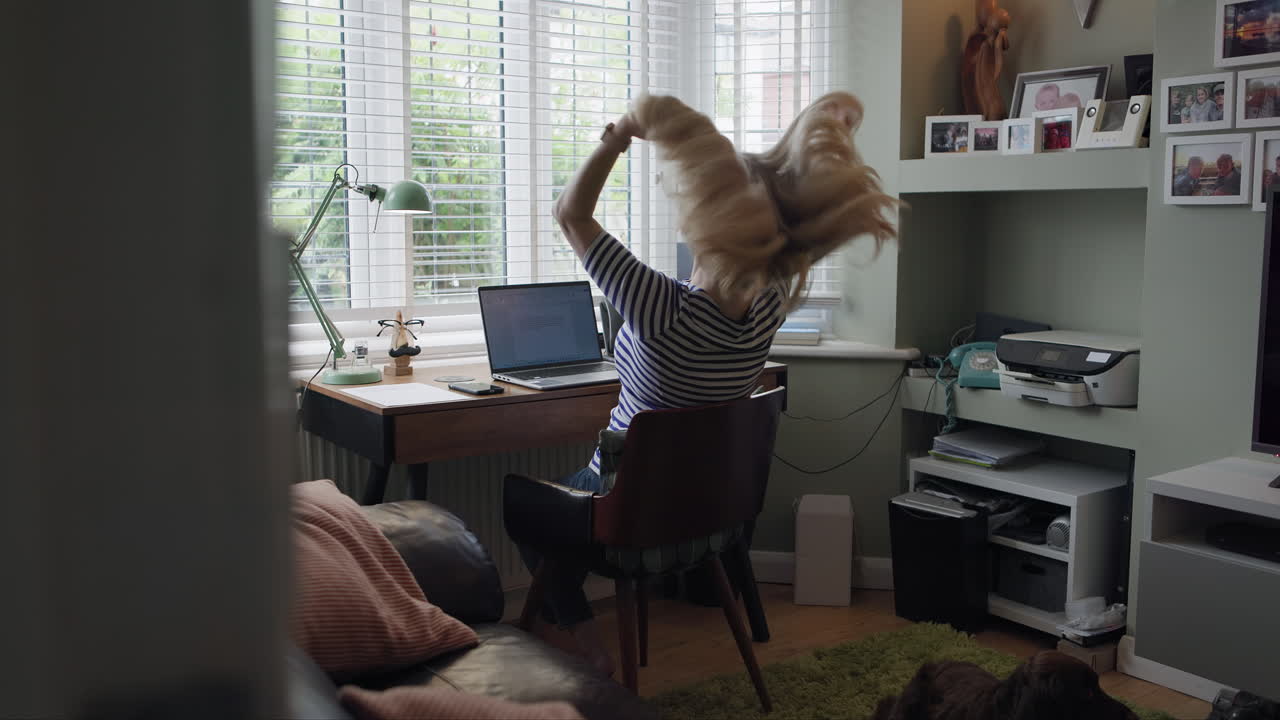 A woman working at her desk in her living room