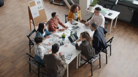 slow motion of men and women colleagues joining hands then applauding working in office together