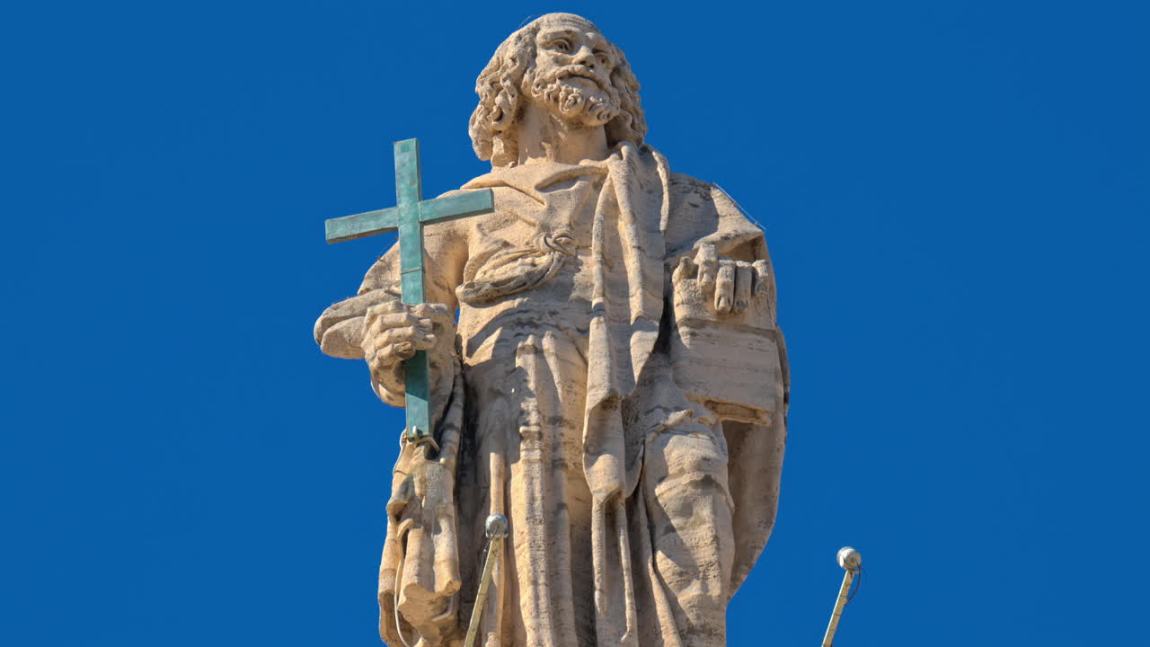 Statues on the Facade of St. Peter's Basilica on the blue sky background, in St. Peter's Square, Vatican City, Rome, Italy