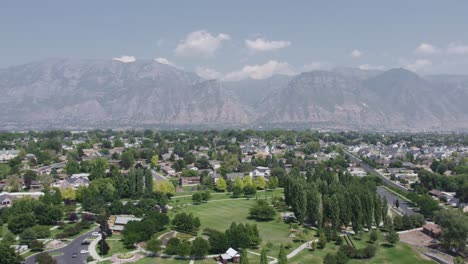 wasatch mountain range in background of orem city, utah county - aerial