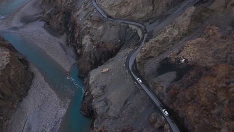 mountain road winding through a canyon with turquoise river