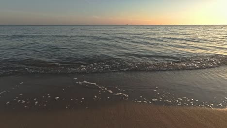 calm water - sea waves at the beach at the morning sunrise around 6a - close up