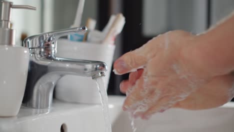 man washing his hands in slow motion
