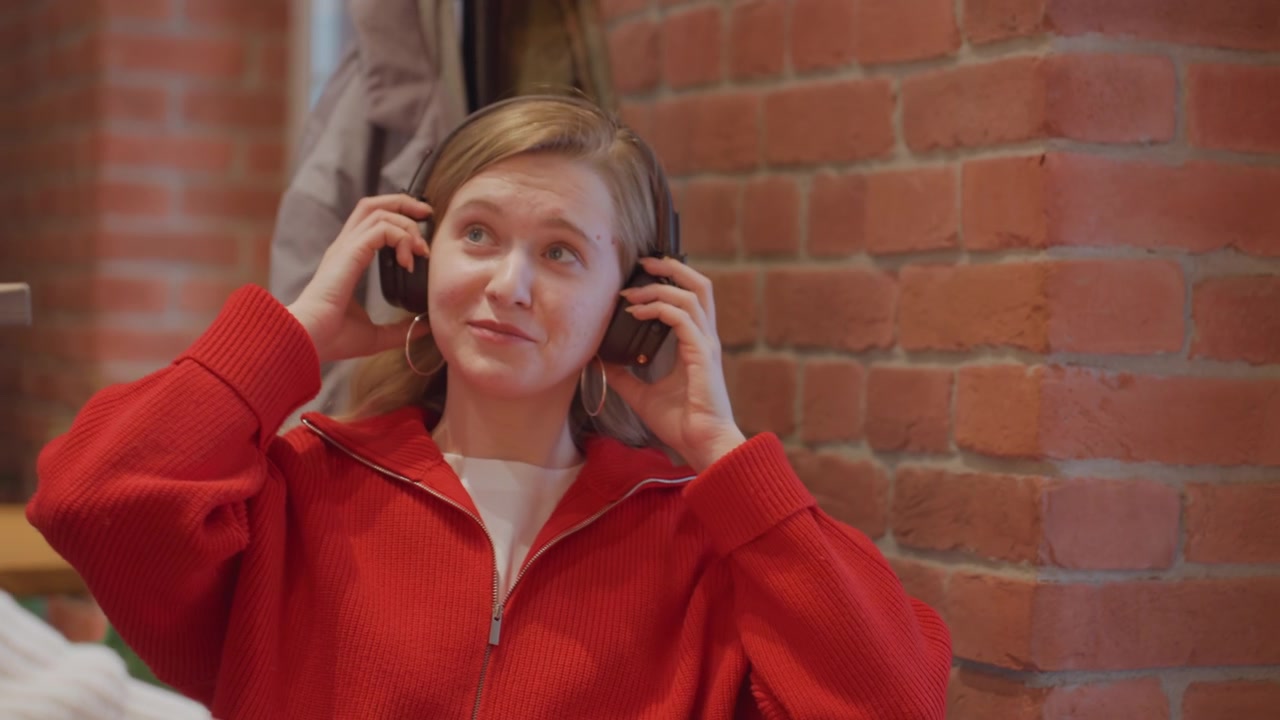 Young Woman Receives Coffee from Barista in a Cozy Cafe