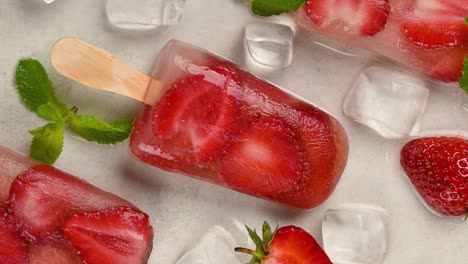 strawberry ice popsicle rotating on table