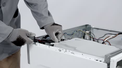 removing tubes that connect to detergent drawer