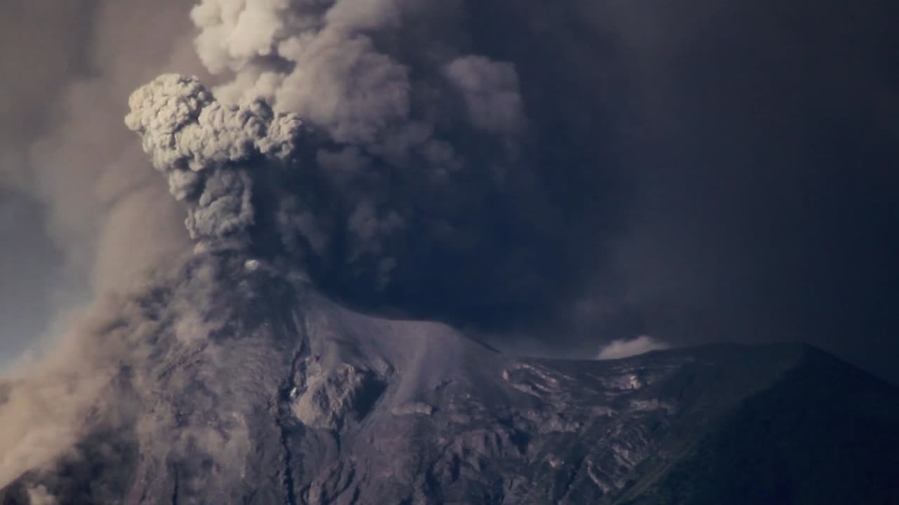 Fuego Volcano erupts heavily, shooting pyroclastic material into the sky and covering its surrounding area in ash