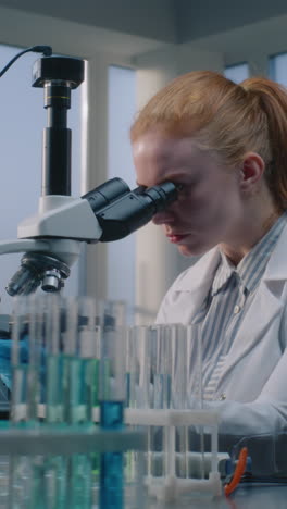 scientist working with microscope in a laboratory