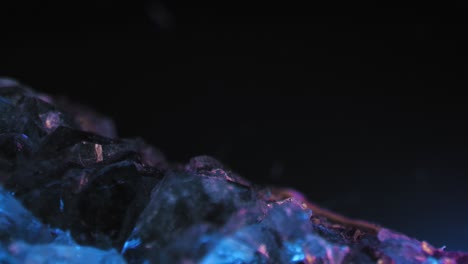 sartén suave y cautivadora de un cristal de amatista púrpura iluminado contra un fondo negro