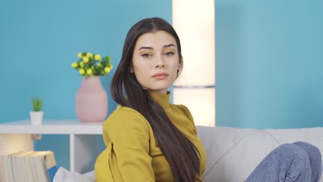 Young-woman-looking-at-camera-thoughtfully-feeling-unhappy-and-sad.