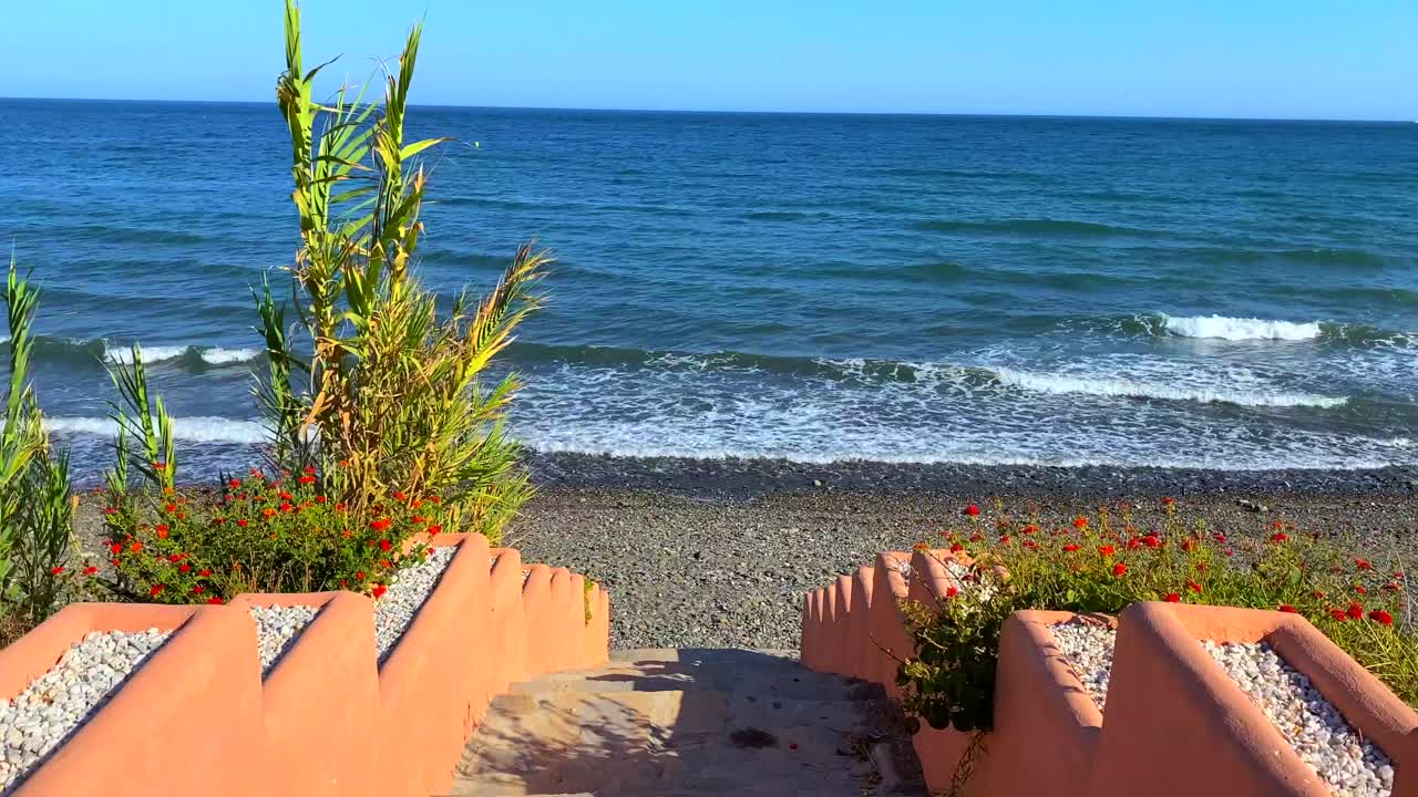 Beautiful stairs to the ocean, steps leading down to the sea in Marbella Estepona, Spain, 4K