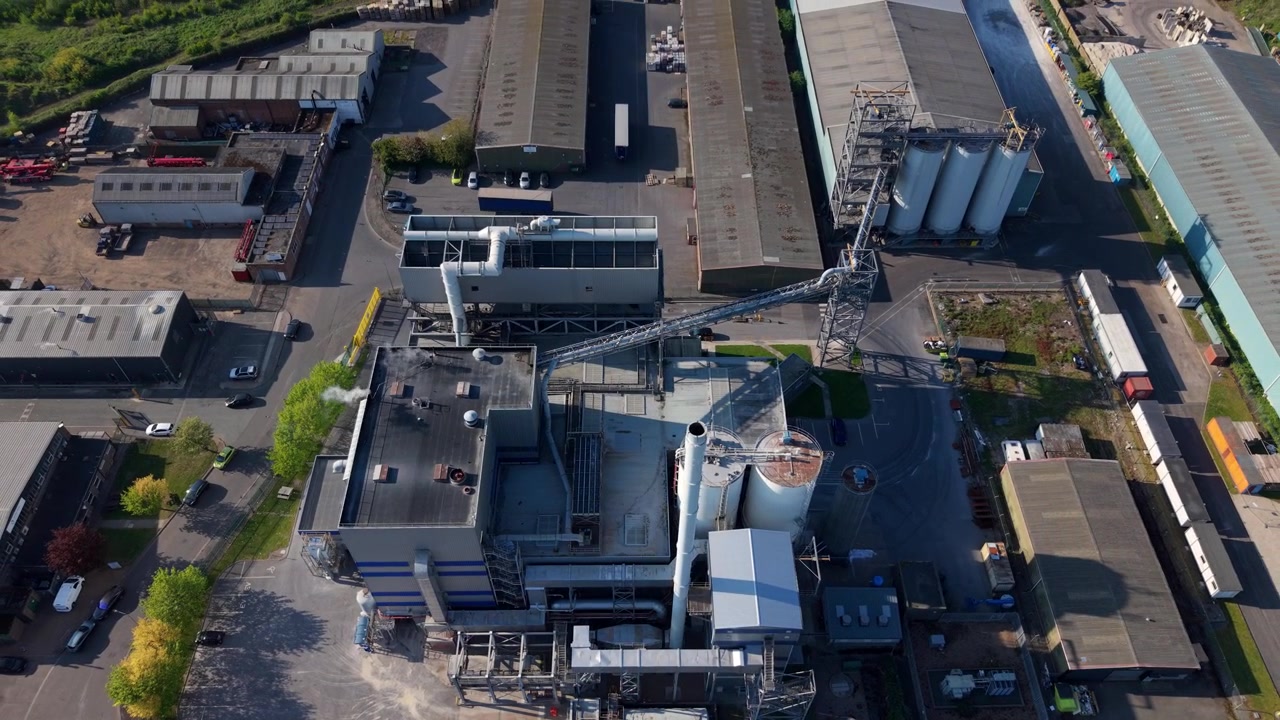 Top-down aerial drone view of a modern energy recovery facility and industrial yard in the UK