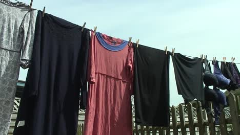 clothes hanging on a washing line using wooden pegs in the back garden of a home in oakham in the county of rutland in england, united kingdom