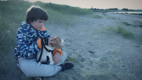 4k outdoor seaside child and dog posing on beach