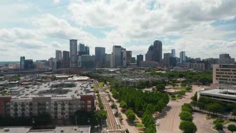 Aerial-drone-view-of-wide-skyline-from-drone-ascending-above-low-houses-in-neighborhood.-Dallas,-Texas,-US