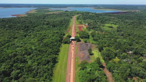 incredible exotic road crossing a jungle and a large lake in misiones, argentina
